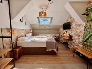 a small bedroom with a bed and a tv at Aparthotel Fairschlafen Minden in Minden