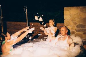 a group of people in a bubble bath at Апартаменти Helleborus in Staryy Mizunʼ +104 photos