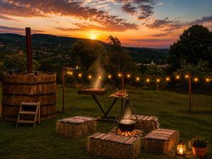 a grill in a field with a sunset in the background at A&D House in Novaci-Străini