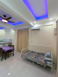 a room with a bed and a table and a ceiling at TBSC by Reemon in Keningau