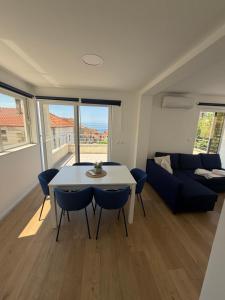 a living room with a table and a couch at Apartmani Paula in Makarska