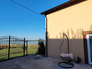 a chair sitting in front of a building with a gate at Casa Joe in Corbu