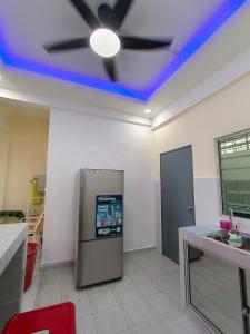 a kitchen with a blue ceiling with a ceiling fan at TBSC by Reemon in Keningau