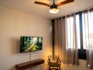 a living room with a flat screen tv on the wall at Apto Gonzaga a 20m da praia -Ar Split & Pet Friendly in Santos