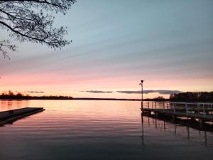 a dock on a lake at sunset at Apartament w centrum in Biskupiec