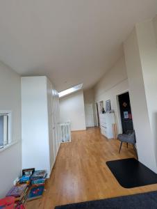 an empty living room with a table and a chair at Kongleveien 11C in Sandnes