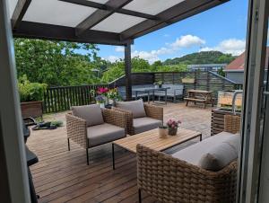 a patio with chairs and a table on a deck at Kongleveien 11C in Sandnes