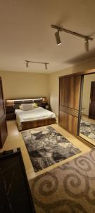 a bedroom with a bed and a large rug at Tara Home 204 in Sheikh Zayed