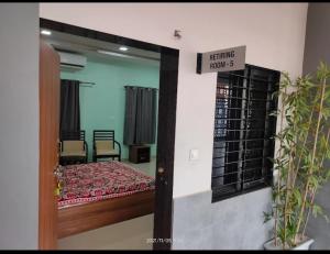 a room with a bed and a sign that reads exiting hour at Rail connect hotel statue of unity in Kevadia +3 photos