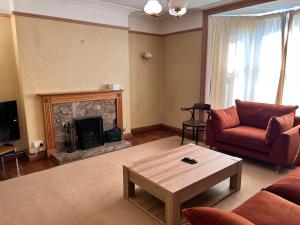 a living room with a couch and a fireplace at Towler's Chemist in Kirkbymoorside