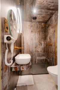 a bathroom with a sink and a toilet at Apartamenty Wieliczka in Wieliczka