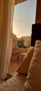 a bedroom with a window with a view of a balcony at Tara Home 204 in Sheikh Zayed