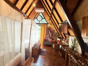 a living room with a ceiling with a window at Cinnamon River Cabana in Ella