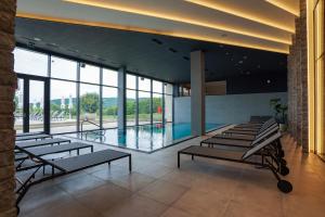 a room with a pool and a bunch of chairs at Degenija Boutique hotel & Spa in Seliste Dreznicko