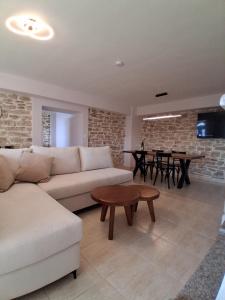 a living room with a couch and a table at Οcalia Apartment in Petrokhórion +18 photos