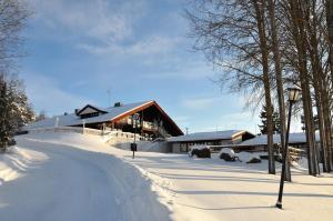 a building covered in snow in front at Hotel Hanhi in Lapinjärvi