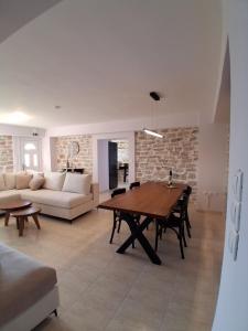a living room with a table and a couch at Οcalia Apartment in Petrokhórion