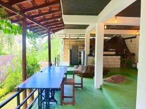 a blue table in the middle of a room at Cinnamon River Cabana in Ella