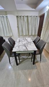 a dining room with a table and chairs at Hill View Haven in Rushikonda