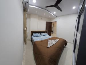 a bedroom with a bed and a ceiling fan at Hill View Haven in Rushikonda