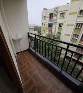 a balcony with a sink and a view of a building at Hill View Haven in Rushikonda +26 photos