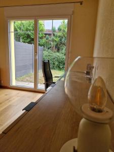 a wine glass sitting on top of a wooden table at Villa dolce vita in Murten +44 photos
