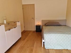 a bedroom with a bed and a table with a candle at Villa dolce vita in Murten