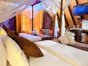 a bedroom with two beds with stuffed animals on them at Cinnamon River Cabana in Ella