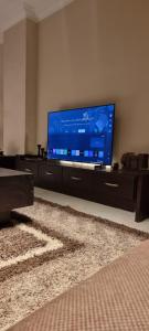 a living room with a large flat screen tv at Tara Home 204 in Sheikh Zayed