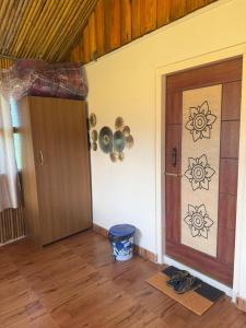 an empty room with a door and a wooden floor at Marmo in Ziro