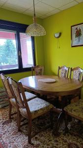 a dining room with a wooden table and chairs at Villa Tira in Jajce
