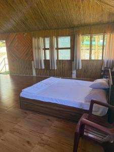 a bedroom with a large bed and a chair at Marmo in Ziro