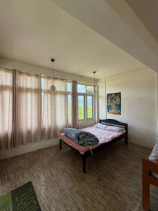 a bedroom with a bed and a large window at Marmo in Ziro
