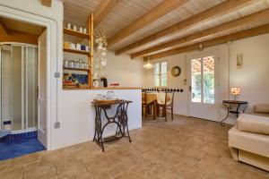 a kitchen and living room with a table and chairs at Lošinj house Robinzon Studenčić Island Lošinj in Čunski