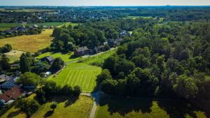 an aerial view of a village with a farm and trees at Ferienwohnung im Grünen in Korschenbroich