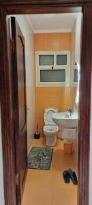 a bathroom with a toilet and a sink at Tara Home 204 in Sheikh Zayed +17 photos