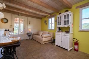 a living room with a couch and a table at Lošinj house Robinzon Studenčić Island Lošinj in Čunski