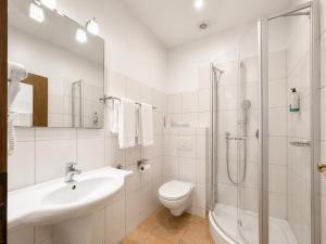 a bathroom with a sink toilet and a shower at Hotel Kaiserhof in Lehrte