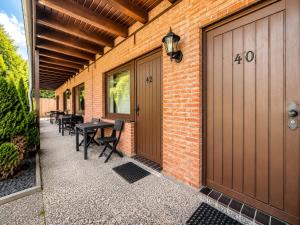 a patio with a table and chairs next to a building at Hotel Kaiserhof in Lehrte