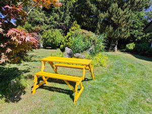 a yellow picnic table sitting in the grass at Büchelblick Camping in Monschau +3 photos