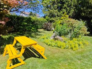 a yellow picnic table sitting in the grass at Büchelblick Camping in Monschau