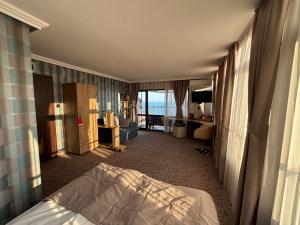 a hotel room with a bed and a view of the ocean at Vila Vista Вила Виста in Sveti Vlas +152 photos
