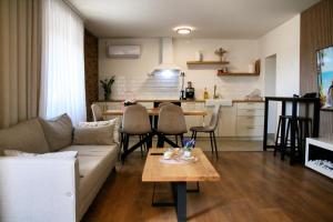 a living room with a couch and a table at Vila Daško in Lukavac