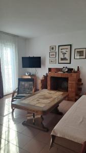 a living room with a table and a fireplace at Apartment Feral in Neum
