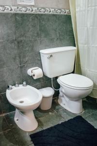 a bathroom with a toilet and a sink at Hotel Del Parque in Corrientes +19 photos