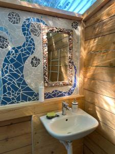 a bathroom with a sink and a mirror at Martinická jurta in Martinice u Dolních Kralovic +48 photos