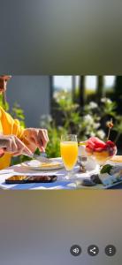 a person sitting at a table with a glass of orange juice at Logement Hellevoetsluis in Hellevoetsluis +57 photos