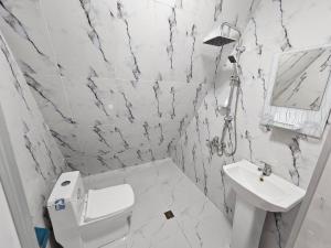 a white bathroom with a toilet and a sink at Dreamvilla aframe in Gabala +34 photos