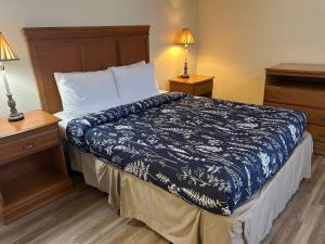 a bedroom with a bed with a blue and white comforter at The Inn at Cedar Grove in Vicksburg