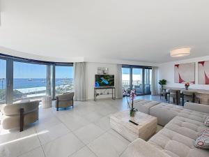 a living room with a couch and a table with a television at 7 Croisette in Cannes